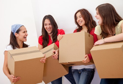 Moving team preparing items safely with protective handling equipment