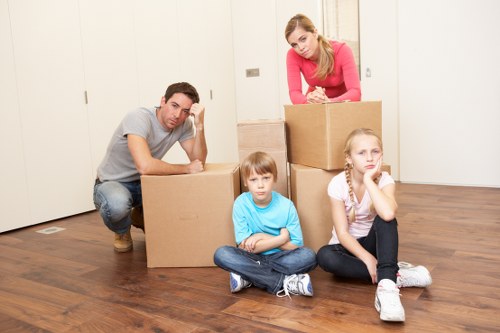 Home movers loading furniture outside an Isleworth property