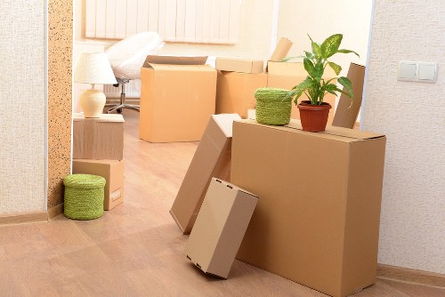 Packed moving boxes and furniture ready for transport in Isleworth