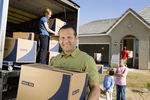 Local movers preparing fragile items and furniture for transport